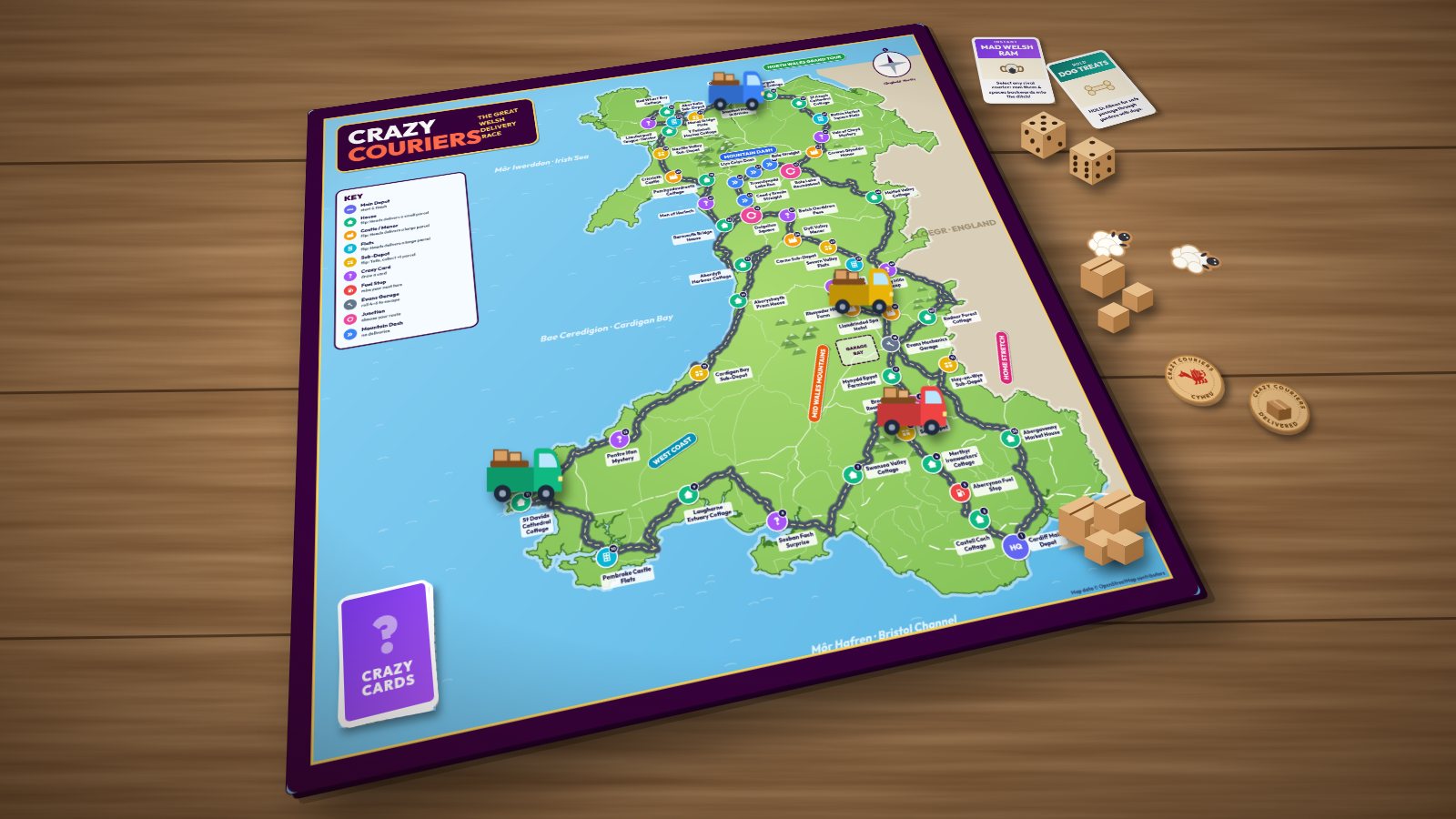 Render of the Crazy Couriers map-of-Wales board on a wooden table with vans, parcels, cards and dice